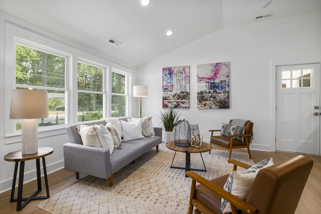 Bright and inviting modern living room featuring elegant furnishings and art pieces.