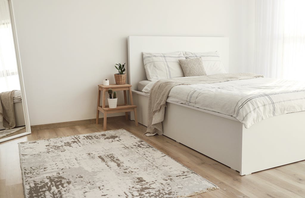 Bright Scandinavian style bedroom with minimalist decor and neutral tones.